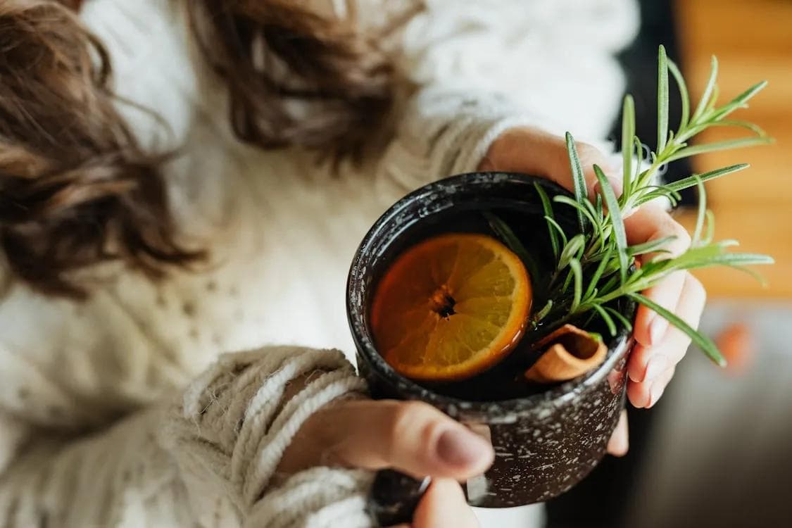 Mulled drink with orange and rosemary and cinnamon